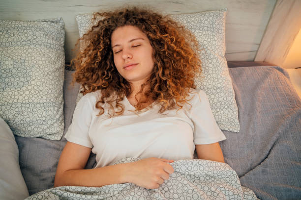 istock Woman sleeping in bed at home 1393020343