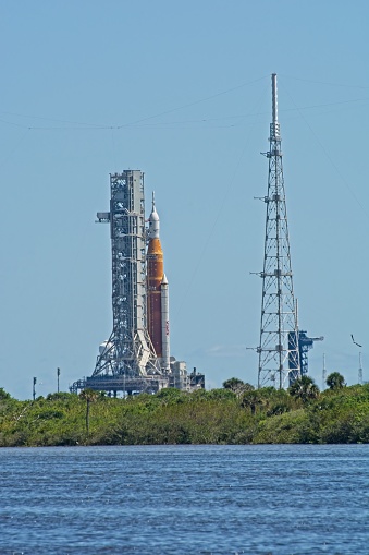 Titusville, FL., USA - April 11, 2022: Artemis 1 rocket capped with Orion crew capsule on launch pad 39B in preparation for prelaunch testing at NASA’s Kennedy Space Center in mid afternoon sun.  Shimmering distant image due to heat haze.