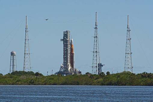 Titusville, FL., USA - April 11, 2022: Artemis 1 rocket capped with Orion crew capsule on launch pad 39B in preparation for prelaunch testing at NASA’s Kennedy Space Center in mid afternoon sun.  Shimmering distant image due to heat haze.