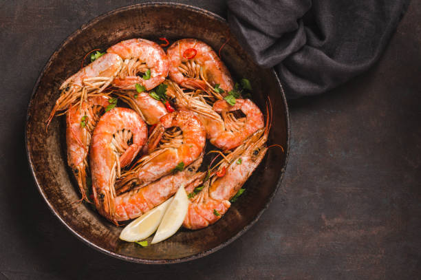 istock Shrimps cooked spicy top view copy space dark background. 1393026213