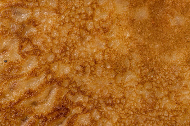 istock Details of freshly made pancakes on a plate. 1393027059