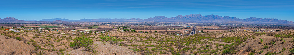 The Rio Grande River flows from the San Juan Mountains in southern Colorado into New Mexico, Texas, Mexico and the Gulf of Mexico.  The Organ Mountains are a rugged mountain range in southern New Mexico on the east side of the Rio Grande Valley.  The range is a continuation of the Franklin Mountains to the south and the San Augustin and San Andres Mountains to the north.  This view of the Rio Grande Valley and Organ Mountains was photographed from the Scenic Overlook Rest Area west of Las Cruces, New Mexico, USA.