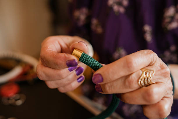 istock Senior woman making hand made necklace 1393031923