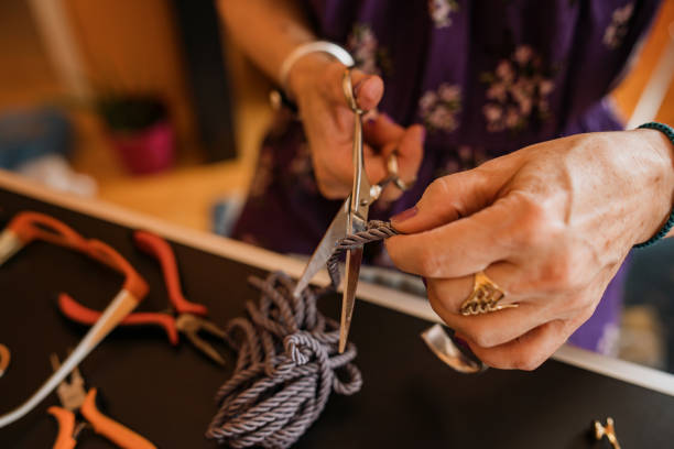 istock Senior woman making hand made necklaces 1393032487