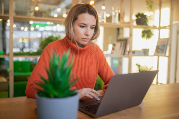 istock Focused young woman typing on laptop keyboard. 1393041452