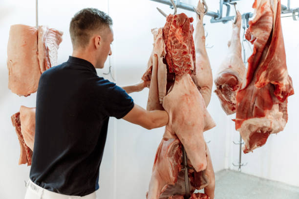 istock Young butcher preparing the meat 1393041547