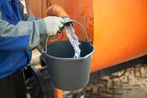 The bucket is filled with water. Preparation of water for irrigation.