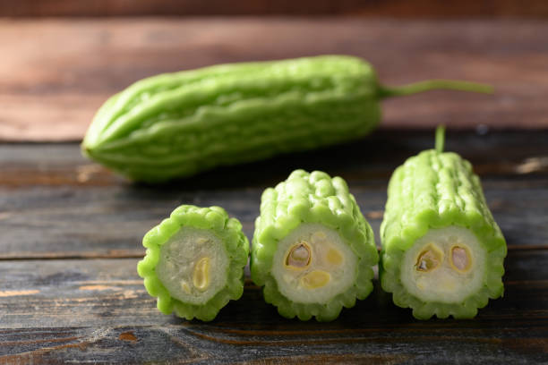 istock Bitter melon or bitter gourd on wooden background 1393045021