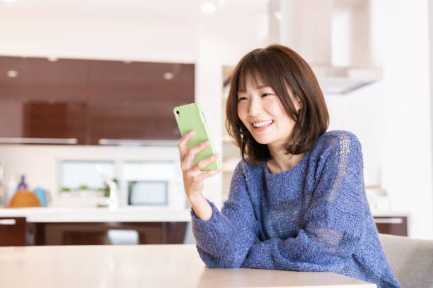 istock attractive Asian woman using a smart phone 1393049585