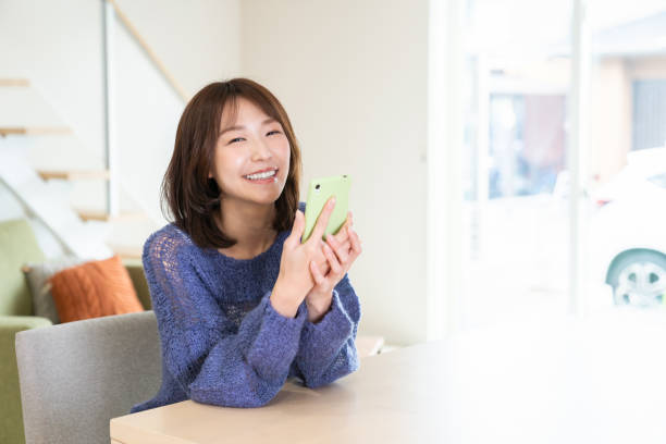 istock attractive Asian woman using a smart phone 1393049629