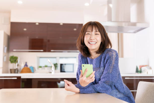 istock attractive Asian woman using a smart phone 1393049658