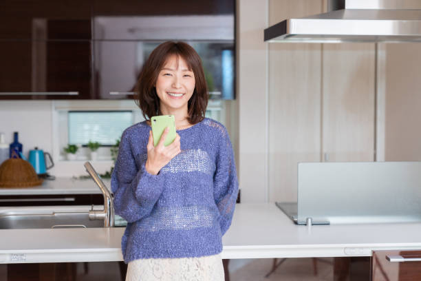 istock attractive Asian woman using a smart phone 1393049669