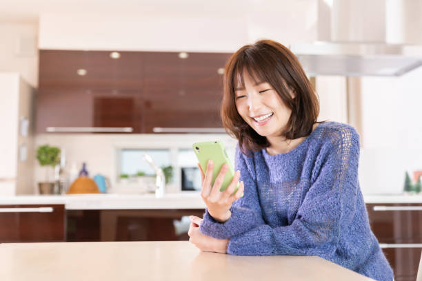 istock attractive Asian woman using a smart phone 1393049694