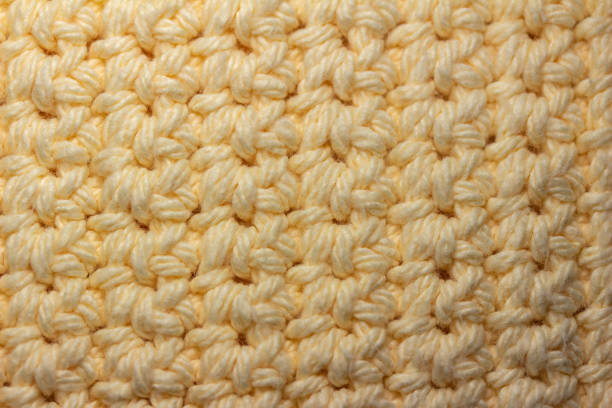 istock Close-up abstract texture view of crocheted fabric in white yarn 1393056343