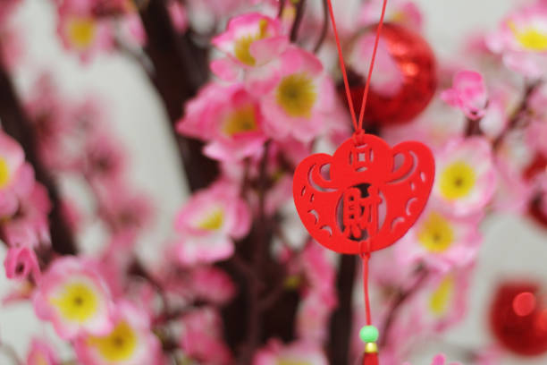 istock Pink cherry blossoms with Chinese ornaments 1393056369