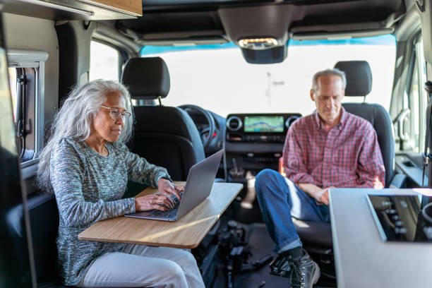 istock Mature adult woman working on computer while traveling 1393058318