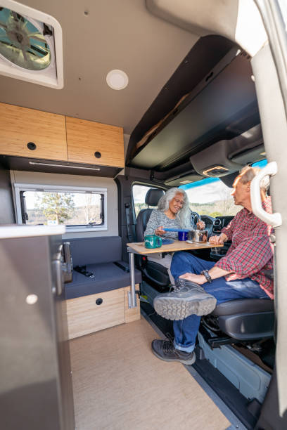 istock Active senior couple enjoying meal in customized camper van 1393058344