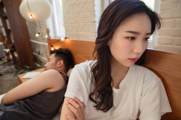 istock The young couple sitting on his bed sulking 1393060764