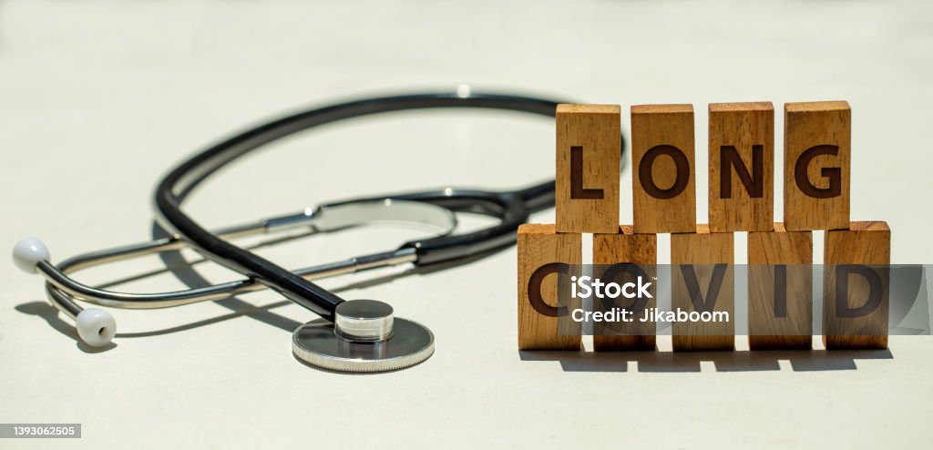 Stethoscope and wooden blocks with wording "LONG COVID" Long COVID Stock Photo