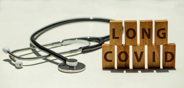 Stethoscope and wooden blocks with wording "LONG COVID" Stethoscope and wooden blocks with wording "LONG COVID" long covid stock pictures, royalty-free photos & images