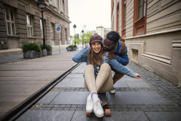 istock Happy couple having fun with skateboard 1393065429