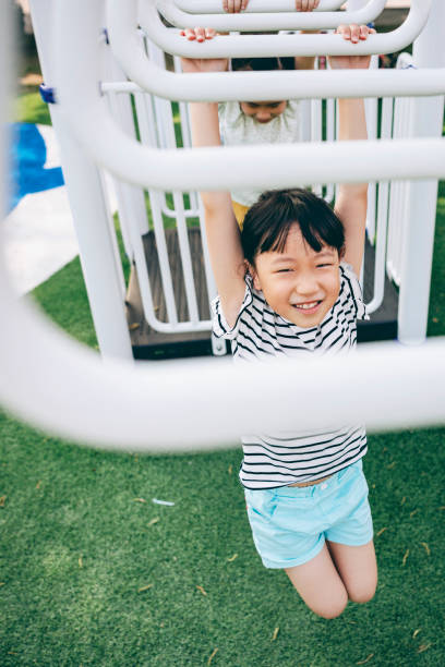 istock Asian kids having fun in the park 1393065674