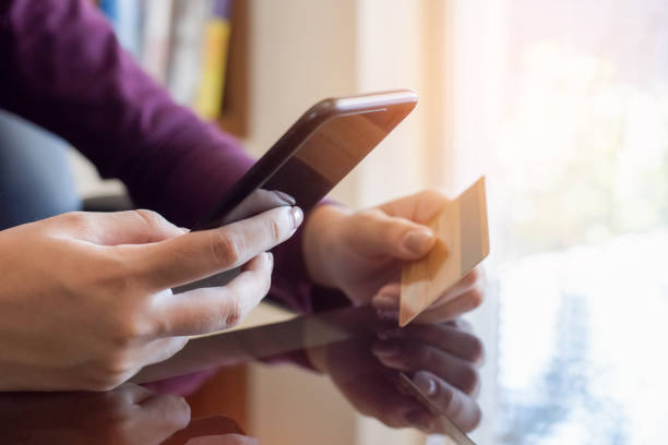 istock female hands holding credit card and using smartphone 1393065723