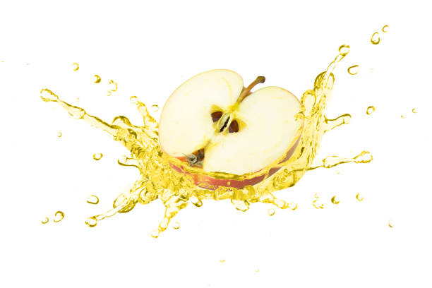 istock Fresh red apple with apple cider vinegar or juice splashing isolated on white 1393065837