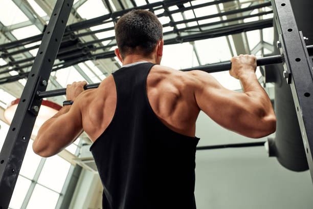 istock Pain during exercise, work with his own weight, the athlete does exercises on the uneven bars overcoming pain 1393066853