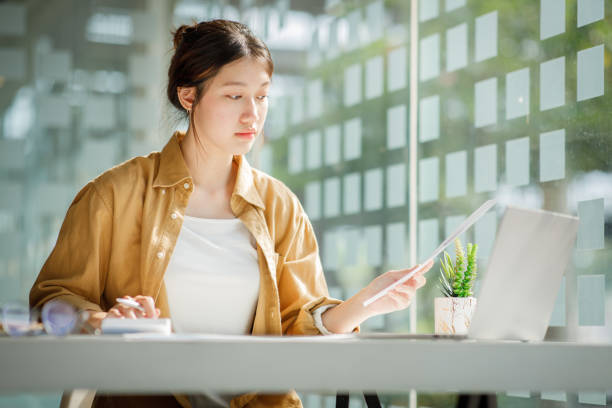 istock Charming Young asian businesswoman sitting on laptop computer 1393067754
