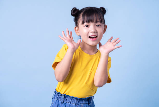 istock Image of Asian child posing on blue background 1393069240