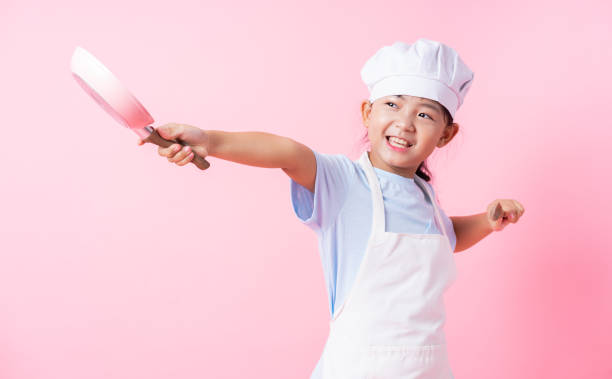 istock Image of Asian child practicing to be a chef 1393069298