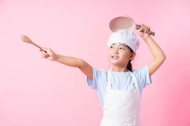 istock Image of Asian child practicing to be a chef 1393069304
