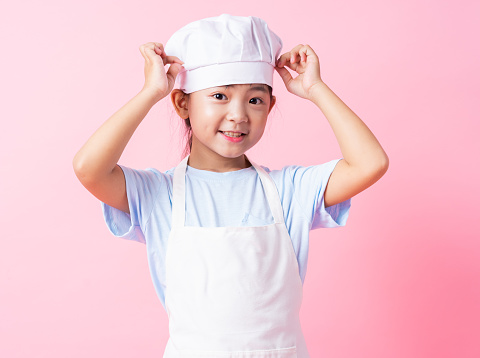 Image of Asian child practicing to be a chef