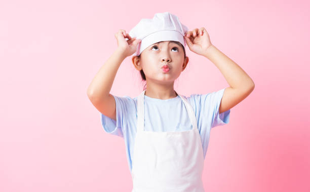 istock Image of Asian child practicing to be a chef 1393069308