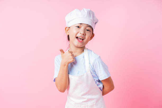 istock Image of Asian child practicing to be a chef 1393069316
