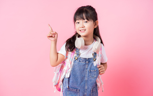 Image of Asian primary school student on pink background