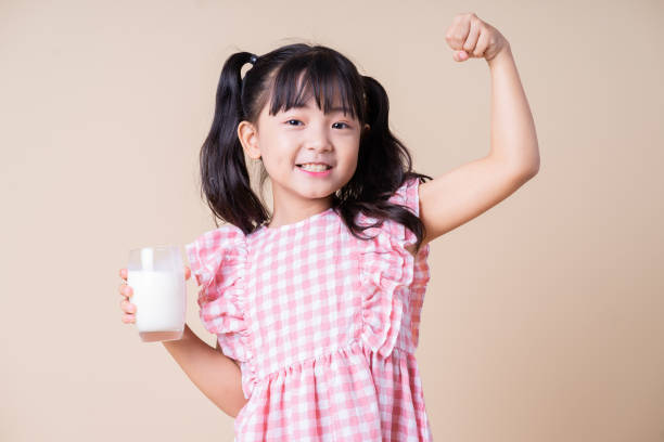 istock Image of Asian child drinking milk on background 1393069442
