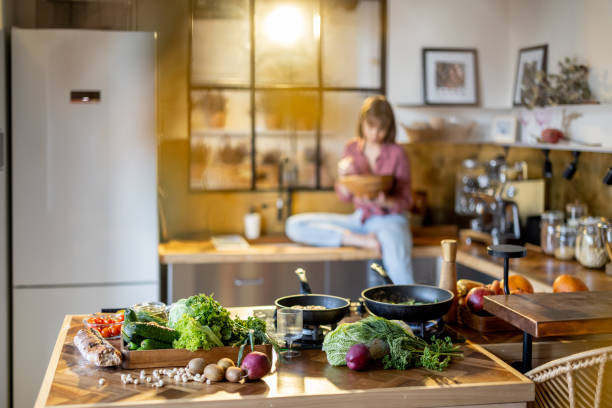 istock Woman eating salad in modern kitchen at home 1393074490