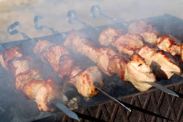 Grilled kebabs on skewers in the open air.
