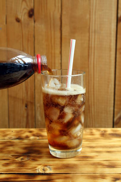 istock Sparkling water is poured into a glass with ice 1393077192