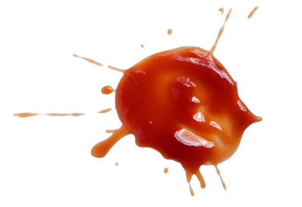 istock Red ketchup splashes isolated on white background with clipping path. tomato sauce texture. from above. 1393079328