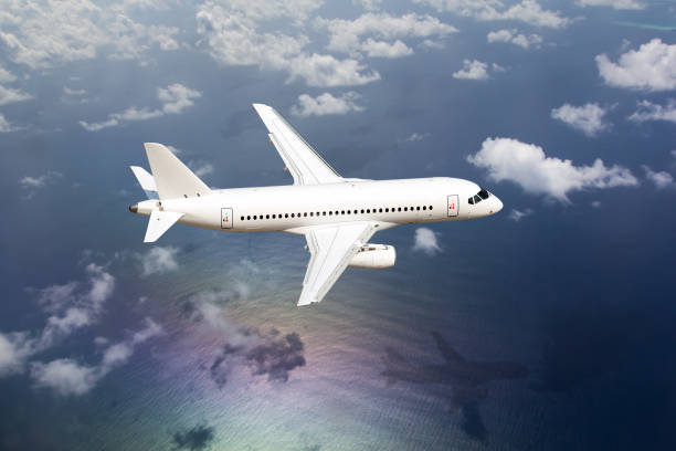 istock Passenger plane flies over the ocean 1393079331