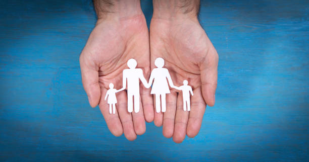istock Human hands showing paper cut family. 1393083674