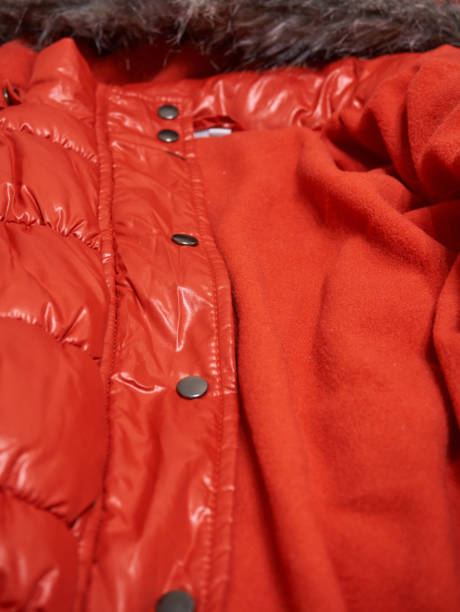 istock Red jacket with close-up rivets. Soft selective selective focus. Clothing detail 1393085555