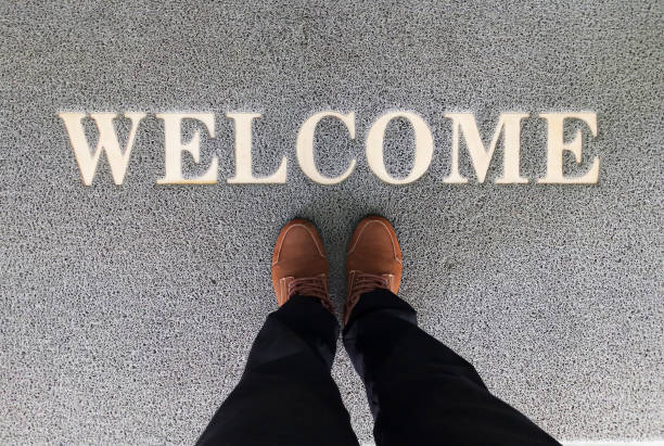 istock Overhead view of man standing on a welcome mat 1393085604