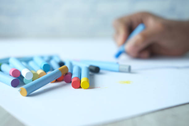 istock Color pencils on yellow papers on table 1393089531