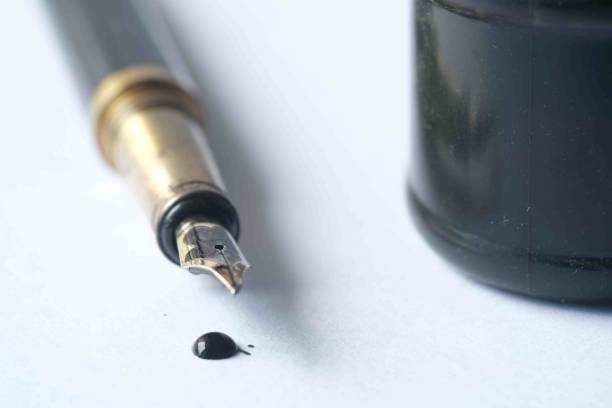 istock ink, empty paper and fountain pen on table 1393089555