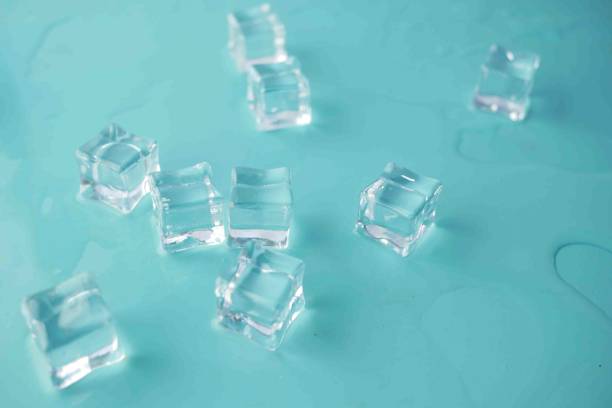 istock top view of many ice cubes on light green background.. 1393089603