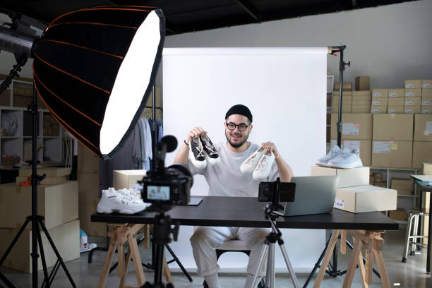 istock Asian man blogger or vlogger looking at camera reviewing product. 1393089633